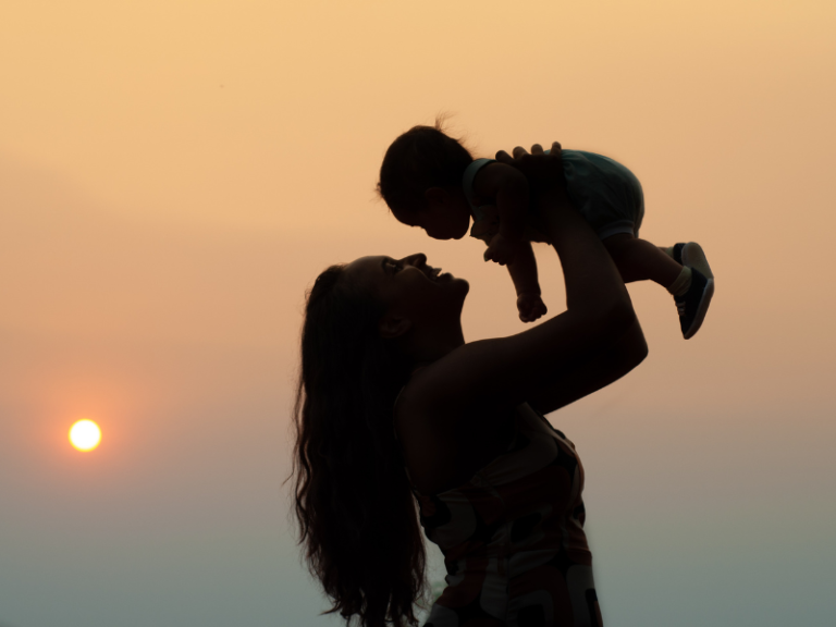 A mom and child silhouette depicting balancing motherhood and life