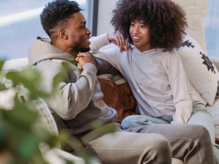 Couple sitting on a sofa having a thoughtful conversation