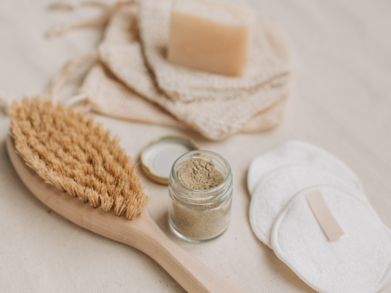 Practising self-care with a body brush and beauty products.